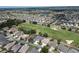 Expansive aerial view showcasing a neighborhood with mature trees and a golf course at 1985 Abordale Ln, The Villages, FL 32162