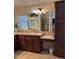 Well-appointed bathroom with vanity, large mirror, and built-in storage at 1985 Abordale Ln, The Villages, FL 32162