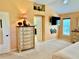 Bright bedroom featuring neutral carpet, ample natural light, a decorative niche, and a view into the bathroom at 1985 Abordale Ln, The Villages, FL 32162