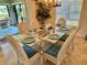 Dining room with glass table, seating for six and backyard view at 1985 Abordale Ln, The Villages, FL 32162