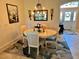 Elegant dining room featuring a chandelier, mirror, and floral rug at 1985 Abordale Ln, The Villages, FL 32162
