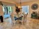 Bright dining room with glass table, seating for six, and decorative chandelier at 1985 Abordale Ln, The Villages, FL 32162