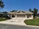 Beautiful three-car garage home featuring a unique driveway design with an inlaid turtle mosaic at 1985 Abordale Ln, The Villages, FL 32162