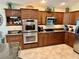 Well-equipped kitchen with stainless steel appliances and rich wood cabinetry at 1985 Abordale Ln, The Villages, FL 32162