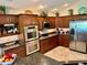 Modern kitchen featuring stainless steel appliances and dark countertops at 1985 Abordale Ln, The Villages, FL 32162
