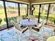 Relaxing lanai with seating, a view of the lawn, and surrounding foliage at 1985 Abordale Ln, The Villages, FL 32162