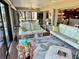 Comfortable lanai with seating areas, view of the dining area, and stylish decor at 1985 Abordale Ln, The Villages, FL 32162