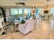 Inviting living room with tile flooring, large windows, and comfortable furnishings at 1985 Abordale Ln, The Villages, FL 32162