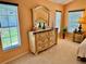 Inviting main bedroom showcasing dresser, side table, and natural light streaming through windows at 1985 Abordale Ln, The Villages, FL 32162
