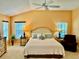 Cozy main bedroom with vaulted ceiling, plush bed, and soft natural lighting at 1985 Abordale Ln, The Villages, FL 32162