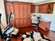 Office with custom cabinetry, a built-in desk, and a floral patterned rug at 1985 Abordale Ln, The Villages, FL 32162