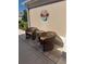 Cozy patio with wicker chairs and table, perfect for relaxing outdoors at 1985 Abordale Ln, The Villages, FL 32162