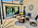 Lovely screened-in patio featuring stylish seating, flower decor, and access to living area at 1985 Abordale Ln, The Villages, FL 32162