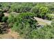 Aerial view of the home and its surroundings, showcasing a lush, treed lot at 201 W Mirror Lake Dr, Fruitland Park, FL 34731