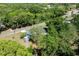 Aerial view of the property showcasing its location, surrounded by lush trees and a peaceful residential neighborhood at 201 W Mirror Lake Dr, Fruitland Park, FL 34731