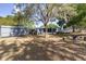 View of the backyard featuring a shed, fire pit, and fencing at 201 W Mirror Lake Dr, Fruitland Park, FL 34731