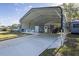 Large carport with ample parking space and convenient access to the house at 201 W Mirror Lake Dr, Fruitland Park, FL 34731
