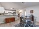 Dining area is open to the kitchen featuring a round table, wood floors, and natural light at 201 W Mirror Lake Dr, Fruitland Park, FL 34731