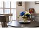 Close up of dining table featuring a stylish flower arrangement, wood floors, and natural light at 201 W Mirror Lake Dr, Fruitland Park, FL 34731