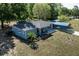 Charming single-story home with a metal carport and a fenced yard showcasing a well-maintained landscape at 201 W Mirror Lake Dr, Fruitland Park, FL 34731