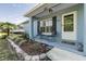 Charming front porch with seating, complemented by beautiful landscaping and a welcoming entrance at 201 W Mirror Lake Dr, Fruitland Park, FL 34731