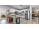 Spacious kitchen featuring stainless steel appliances, white cabinets and a breakfast bar at 201 W Mirror Lake Dr, Fruitland Park, FL 34731