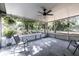 Open screened-in porch with a ceiling fan and peaceful views of the surrounding yard at 201 W Mirror Lake Dr, Fruitland Park, FL 34731