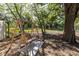 Relaxing backyard swing surrounded by mature trees, perfect for outdoor enjoyment at 201 W Mirror Lake Dr, Fruitland Park, FL 34731