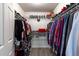 Spacious walk-in closet with built-in shelving, hanging rods, and wood-look flooring at 201 W Mirror Lake Dr, Fruitland Park, FL 34731