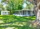 A spacious backyard with a shed and screened in porch surrounded by mature trees for peaceful outdoor enjoyment at 203 Se 30Th Ave, Ocala, FL 34471