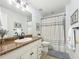 Bright bathroom featuring tile floors, a shower with curtain, and neutral accents at 203 Se 30Th Ave, Ocala, FL 34471
