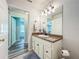 Bathroom vanity with granite countertop, wood cabinets, and decorative mirror at 203 Se 30Th Ave, Ocala, FL 34471