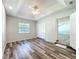 Comfortable bedroom featuring a trey ceiling, ceiling fan, and window letting in natural light at 203 Se 30Th Ave, Ocala, FL 34471