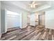 Bedroom with spacious walk-in closet, wood-look floors, and access to bathroom at 203 Se 30Th Ave, Ocala, FL 34471