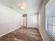 Cozy bedroom with wood-look flooring, large closet, and neutral paint at 203 Se 30Th Ave, Ocala, FL 34471