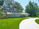 Lovely single-story house with a curved driveway, well-kept lawn, and a welcoming front porch at 203 Se 30Th Ave, Ocala, FL 34471