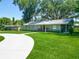 Charming single-story home with a well-manicured lawn and a welcoming front porch, perfect for relaxation at 203 Se 30Th Ave, Ocala, FL 34471