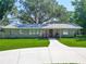 Beautiful single-story home featuring a well-maintained lawn, circular driveway, and inviting front porch at 203 Se 30Th Ave, Ocala, FL 34471