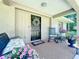 Welcoming front porch featuring a bench, rocking chair, decorative wreath and colorful floral arrangements at 203 Se 30Th Ave, Ocala, FL 34471