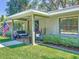 Cozy front porch with seating, decorative plants, and a welcoming entrance to the home at 203 Se 30Th Ave, Ocala, FL 34471