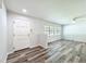 Bright living room featuring new floors, a ceiling fan, and a large window providing natural light at 203 Se 30Th Ave, Ocala, FL 34471