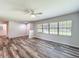 Bright living room showcasing wood-look floors, neutral walls, and abundant natural light from large windows at 203 Se 30Th Ave, Ocala, FL 34471
