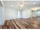 Living room with vaulted ceiling, wood-look flooring, and a ceiling fan at 203 Se 30Th Ave, Ocala, FL 34471