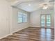 Comfortable living room offering natural light, a vaulted ceiling, a fan, and access to the patio through french doors at 203 Se 30Th Ave, Ocala, FL 34471