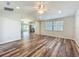 Living room with vaulted ceilings, recessed lighting, wood-look flooring, and a large window at 203 Se 30Th Ave, Ocala, FL 34471