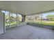 Large screened-in porch with concrete flooring and backyard views at 203 Se 30Th Ave, Ocala, FL 34471