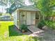 A backyard shed featuring a small porch, ramp, and space for storage or a hobby area at 203 Se 30Th Ave, Ocala, FL 34471