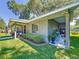 Charming home exterior featuring a covered porch area with stylish seating and lush landscaping at 203 Se 30Th Ave, Ocala, FL 34471