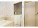 Bathroom featuring a shower, a soaking tub, and decorative wallpaper at 20631 Prince Ranier Pl, Leesburg, FL 34748