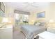 Cozy bedroom with ceiling fan, decorative artwork, and bright window at 20631 Prince Ranier Pl, Leesburg, FL 34748
